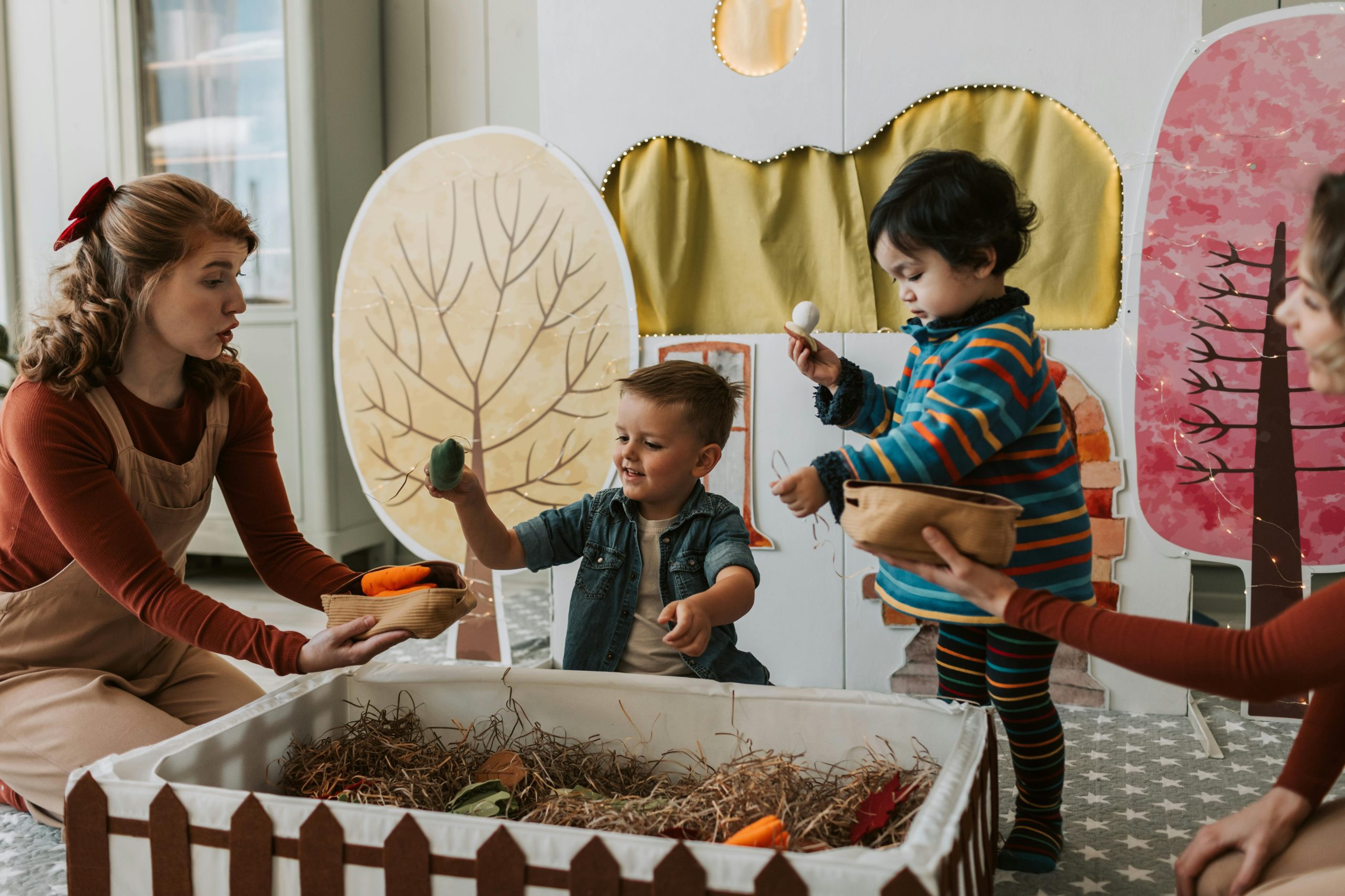 A group of children from Little Big People role playing with the early childhood teacher.